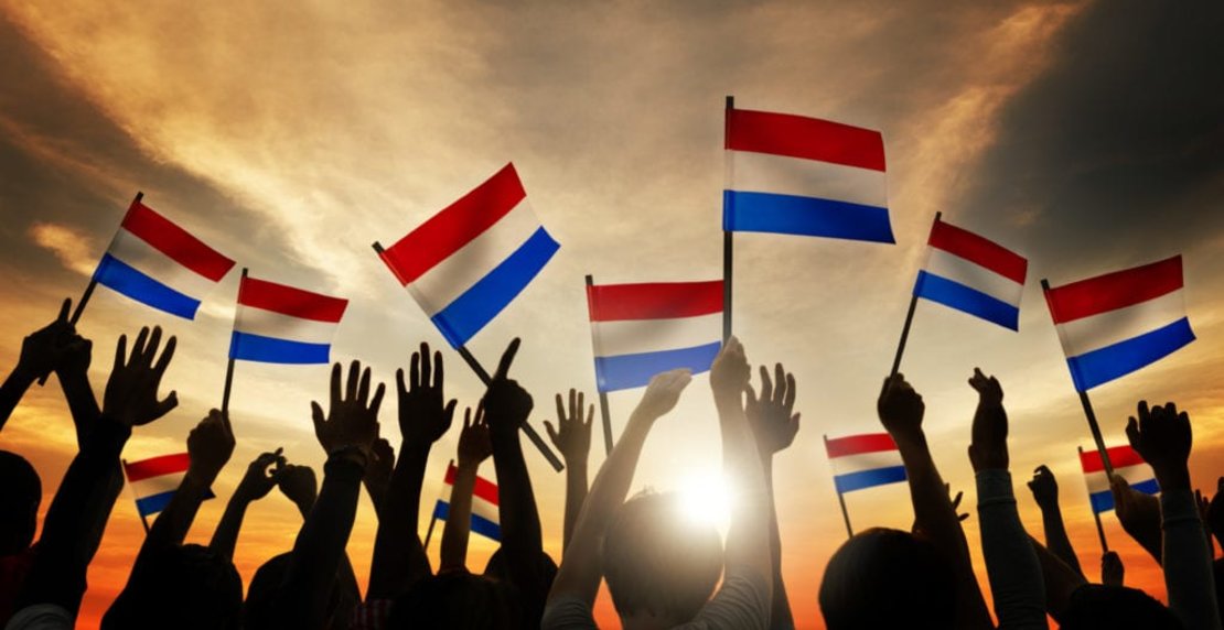 Silhouettes,Of,People,Holding,Flag,Of,Netherlands