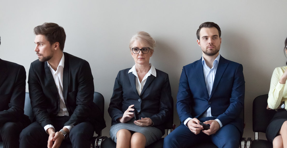 Young and mature candidates waiting for job interview in office